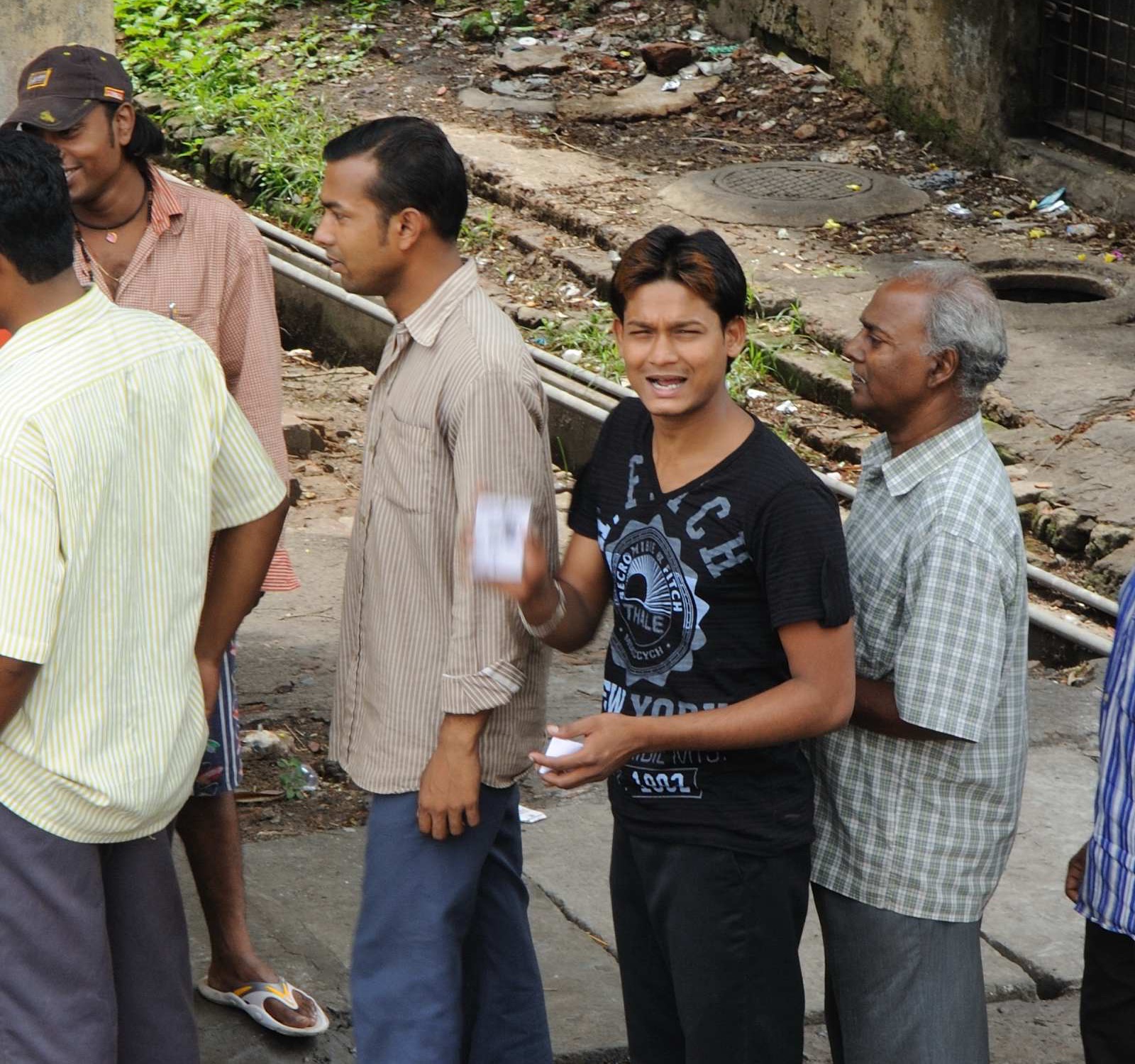 Indian voters standing in queue outside a polling station